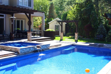 Hot tub - mid-sized contemporary backyard stone and rectangular lap hot tub idea in Toronto