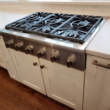 Professional cook top flanked by built in spice racks