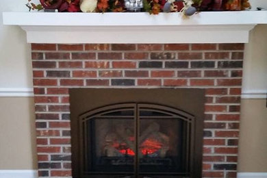 Example of a light wood floor living room design in Philadelphia with white walls, a standard fireplace and a stone fireplace
