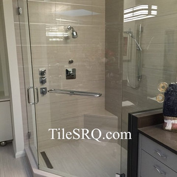 Custom-built shower using chrome Schluter in between each row of tile.