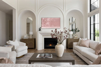 Living room - modern open concept medium tone wood floor, brown floor and wall paneling living room idea in Kansas City with white walls, a standard fireplace, a stone fireplace and a wall-mounted tv