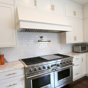 Recessed Cabinet Doors, Wood Island Countertop, and A Custom Hood Defines Style