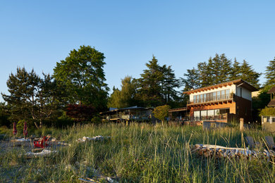 Inspiration for a large asian privacy and partial sun backyard stone landscaping in Seattle.