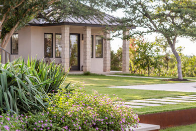 Inspiration for a contemporary drought-tolerant and full sun backyard concrete paver walkway in Austin.