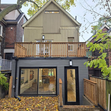 The rear elevation with the roof deck above the extension and its sliding doors,