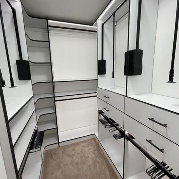 Contrasting Elegance: Custom White Walk-In Closets with Bold Black Frame Accents