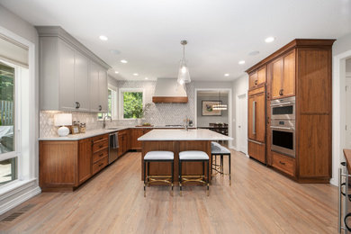 Kitchen - huge traditional u-shaped medium tone wood floor and brown floor kitchen idea in Portland with a drop-in sink, shaker cabinets, gray cabinets, quartz countertops, gray backsplash, ceramic backsplash, paneled appliances, an island and white countertops