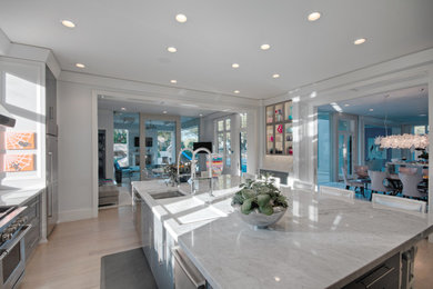 Kitchen photo in Oklahoma City with marble countertops, white backsplash and stone slab backsplash
