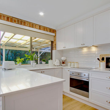 Clean White Kitchen with brushed nickel handles