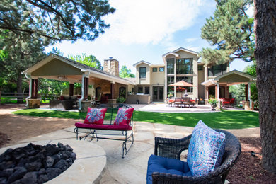 Large backyard concrete patio kitchen photo in Denver with a roof extension