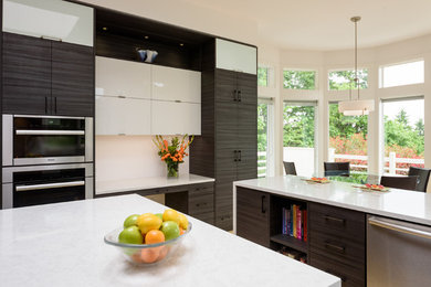 Inspiration for a large contemporary bamboo floor kitchen remodel in Seattle with an undermount sink, flat-panel cabinets, gray cabinets, quartz countertops, white backsplash, stainless steel appliances and an island