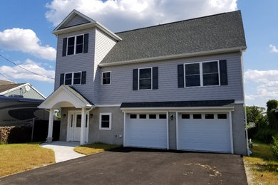 Mid-sized elegant gray two-story vinyl exterior home photo in New York with a shingle roof