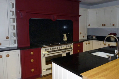 Photo of a medium sized scandinavian single-wall enclosed kitchen in Other with shaker cabinets, red cabinets, granite worktops, medium hardwood flooring and an island.