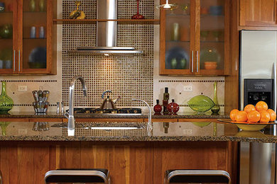 Large transitional single-wall enclosed kitchen photo in Grand Rapids with an undermount sink, shaker cabinets, medium tone wood cabinets, granite countertops, brown backsplash, mosaic tile backsplash, stainless steel appliances and an island