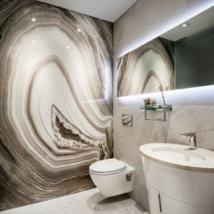 Esempio di una stanza da bagno minimalista con piastrelle beige e lastra di pietra