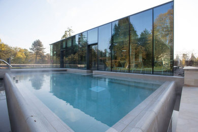 Inspiration for a large modern rectangular swimming pool in Other with tiled flooring.