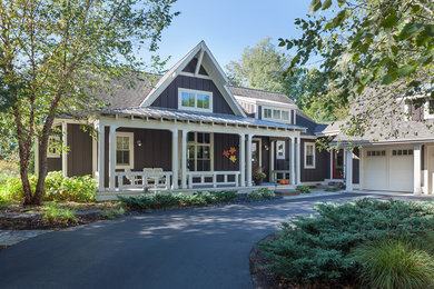 Arts and crafts brown two-story concrete fiberboard house exterior photo in Grand Rapids with a shingle roof