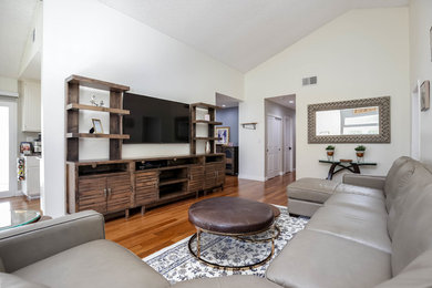 Example of a huge trendy formal and open concept bamboo floor living room design in Los Angeles with white walls, a standard fireplace, a brick fireplace and a wall-mounted tv