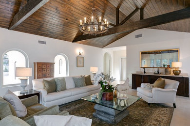Tuscan enclosed beige floor living room photo in Los Angeles with white walls