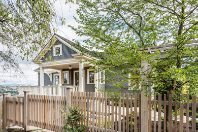 Elegant gray one-story exterior home photo in Seattle with a shingle roof