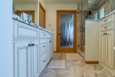Mid-sized elegant 3/4 gray tile and porcelain tile porcelain tile and beige floor alcove shower photo in Denver with recessed-panel cabinets, white cabinets, white walls, granite countertops and a hinged shower door