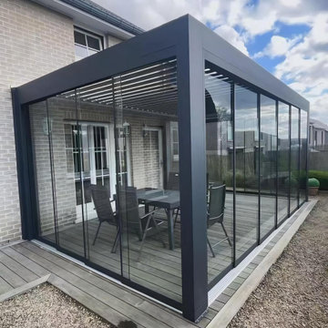 Louvered Motorized Pergola With Sliding Glass Door