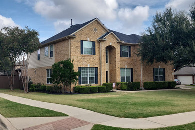 Two-story board and batten exterior home photo in Other