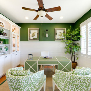 This is an example of a beach style study room in Philadelphia with green walls and a freestanding desk.