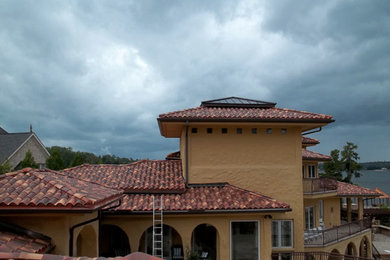 Inspiration for a large coastal yellow two-story exterior home remodel in Charlotte