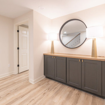 Warm & Inviting Basement Retreat with Custom Bar + Entertainment Center