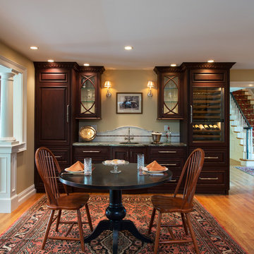 Casual dining area near wine bar and kitchen. Delicious Kitchens & Interiors, L