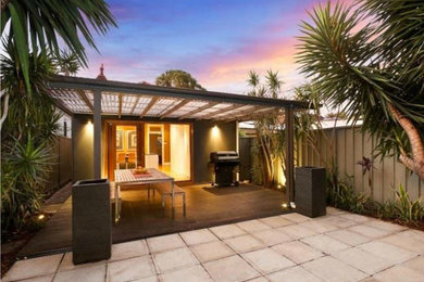 Photo of a contemporary backyard patio in Sydney with an awning.