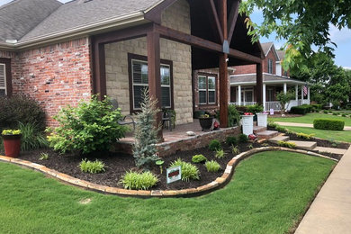 This is an example of a mid-sized rustic partial sun front yard mulch landscaping in Other for spring.