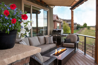 Example of a large trendy backyard second story metal railing deck design in Denver with a fire pit and a pergola