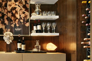 Small minimalist galley carpeted home bar photo in New York with flat-panel cabinets and dark wood cabinets