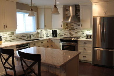 Kitchen - large contemporary l-shaped dark wood floor and brown floor kitchen idea in Toronto with an undermount sink, shaker cabinets, white cabinets, granite countertops, multicolored backsplash, stone tile backsplash, stainless steel appliances and an island