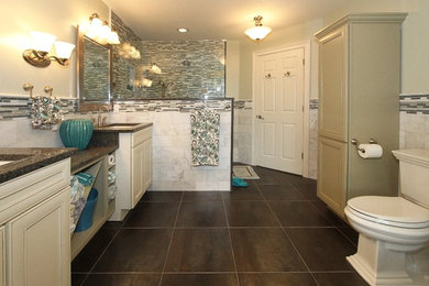 Large transitional master bathroom in New York with raised-panel cabinets, white cabinets, an undermount sink, granite benchtops, a drop-in tub, a one-piece toilet, white tile, green walls and porcelain floors.