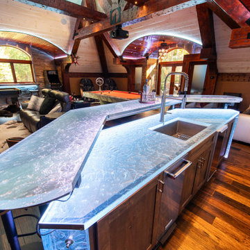 Glass private bar and glass stair treads inside a man cave in Michigan