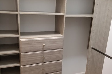Walk-in closet - transitional ceramic tile and gray floor walk-in closet idea in Birmingham with gray cabinets