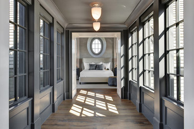 Example of a beach style medium tone wood floor hallway design in Charleston with gray walls