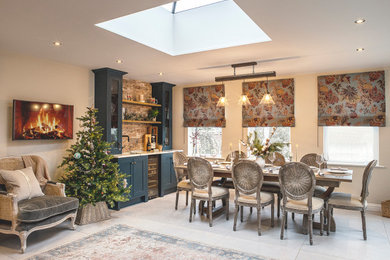 This is an example of an eclectic dining room in Oxfordshire with terra-cotta floors.