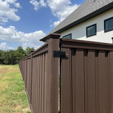 Dark Brown Composite Trex Fence and Black Iron Fence