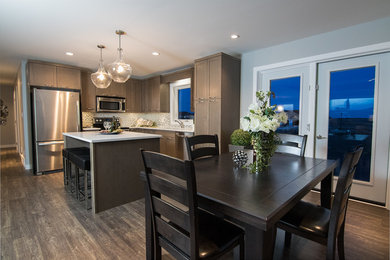 Eat-in kitchen - mid-sized transitional l-shaped dark wood floor and brown floor eat-in kitchen idea in Other with an undermount sink, shaker cabinets, brown cabinets, quartzite countertops, white backsplash, stainless steel appliances and an island