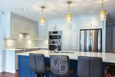 Inspiration for a large transitional l-shaped dark wood floor and brown floor eat-in kitchen remodel in Montreal with an undermount sink, raised-panel cabinets, blue cabinets, quartz countertops, beige backsplash, ceramic backsplash, stainless steel appliances, an island and white countertops