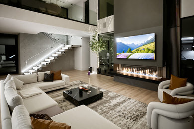 Example of a huge minimalist wood wall living room design in Houston with a metal fireplace