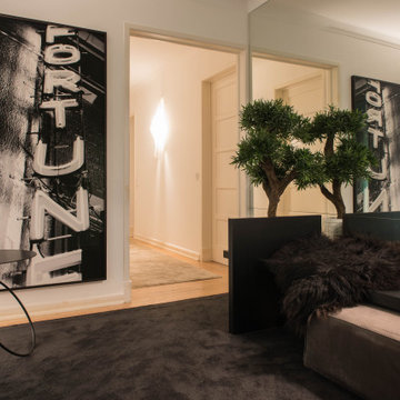 Casa da Moeda entry hall with photography, indoor tree and leather bench