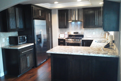 Eat-in kitchen - small contemporary u-shaped dark wood floor eat-in kitchen idea in San Diego with an undermount sink, shaker cabinets, dark wood cabinets, laminate countertops, porcelain backsplash, stainless steel appliances and beige backsplash