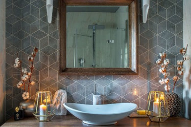 Bathroom - contemporary gray tile bathroom idea in Moscow with flat-panel cabinets, dark wood cabinets, a vessel sink, wood countertops, brown countertops, gray walls and a hinged shower door