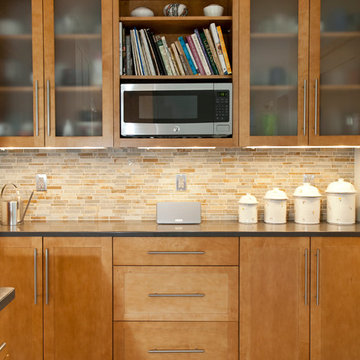 Stone and pewter tile backsplash in this contemporary kitchen