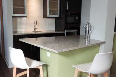 Eat-in kitchen - small 1950s galley ceramic tile eat-in kitchen idea in Chicago with an undermount sink, dark wood cabinets, granite countertops, white backsplash and subway tile backsplash